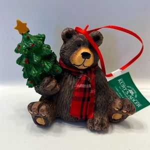 Christmas tree ornament. Adorable bear holding Christmas tree and wearing scarf.